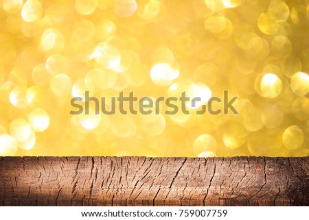 empty wooden on golden lighting backdrop. christmas light background. Wood table top. can used for display or montage your products