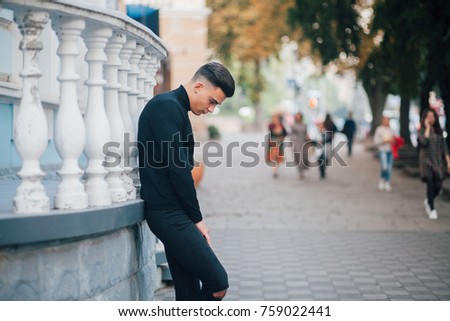 Portrait of young handsome stylish man. Outdoor fashion portrait.