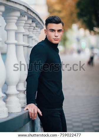 Portrait of young handsome stylish man. Outdoor fashion portrait.