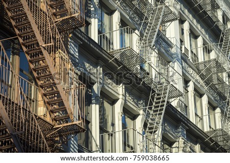 Traditional downtown New York City architecture featuring industrial facades lined with metal fire escapes in the SoHo-Cast Iron Historic District, Lower Manhattan