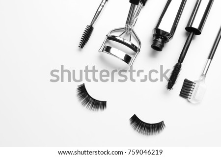Composition with curler and false eyelashes on white background Royalty-Free Stock Photo #759046219