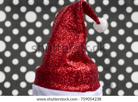 Santa Claus red hat close up isolated on white and black spots in background. Christmas and New Year concept. Copy space