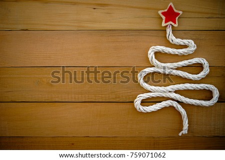 Christmas tree on wooden background.It made by recycle rope.