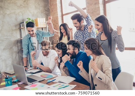 Success and team work concept. Group of business partners with raised up hands in light modern workstation, celebrating the breakthrough in their company Royalty-Free Stock Photo #759071560