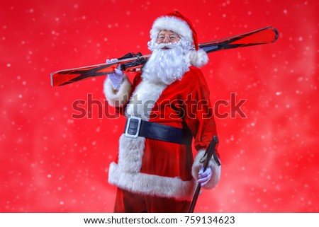 Portrait of Santa Claus holding skiing. Christmas holidays and winter activities.