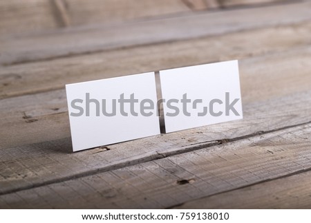Photo of business cards. Template isolated on old wood background. For graphic designers presentations and portfolios damaged weathered antique mock-up with business cards