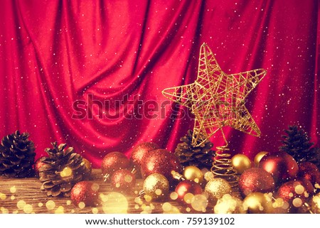 gold star with decor ball on red textile background in christmas