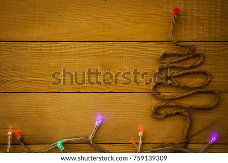 Christmas tree and blinker on wooden background.