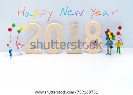 Miniature group happy family holding balloons standing with a wooden 2018 in New Year party on white background, For celebration and decoration to Merry Chrismas & Happy New Year 2018 concept.