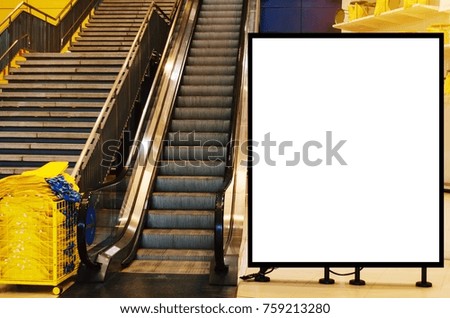 big blank showcase billboard or advertising light box for your text message or media content in front of escalator in modern department store shopping mall, commercial and marketing concept