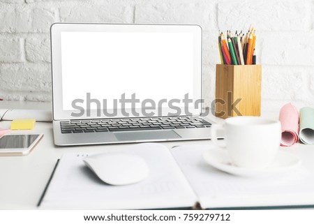 Contemporary workplace with empty white laptop display, smartphone, supplies and other items. Close up. Creative designer office, education, occupation, freelance and lifestyle concept. Mock up 