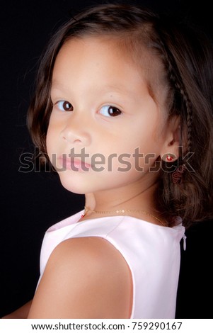 Beautiful young multicultural girl in black background