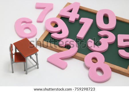 Numbers, desk and blackboard on white background.
Educational concept of mathematics and arithmetic.