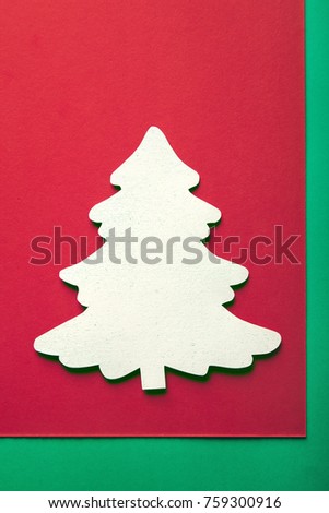 Christmas greeting card background with xmas tree paper cutout. Plenty of space for text. Simple composition