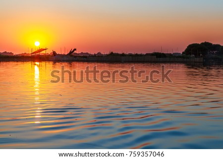 sunset at U Bein bridge, Taung Tha Man Lake in Amarapura, Mandalay, Myanmar.