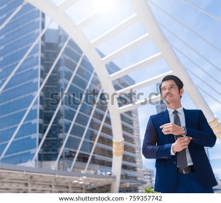 Successful business man with office buildings in the background