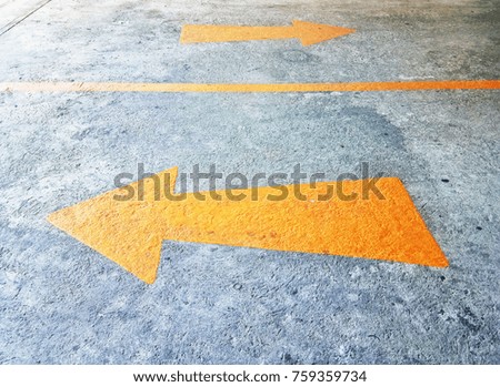 Yellow traffic arrow on the street