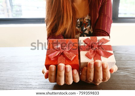 Gifts box on women 's hand,Christmas concept.