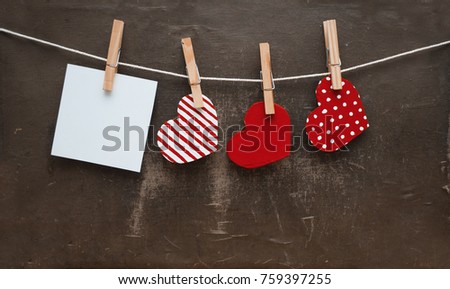 Love hearts and a photo hanging on rope on grunge background 