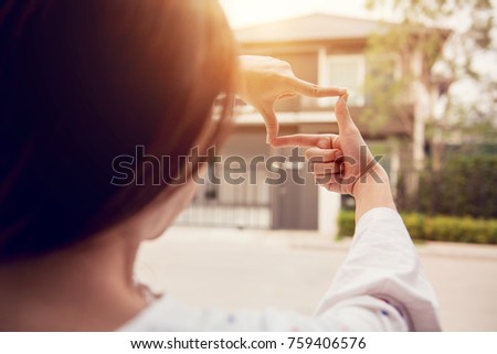 Hands of woman making frame gesture with home background. Planning for the future resident concept.