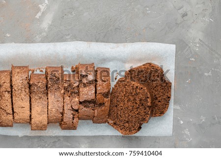 Pieces of chocolate banana cake on a gray concrete background with cocoa powder. Perfect tasty background!)
Flat lay, top view