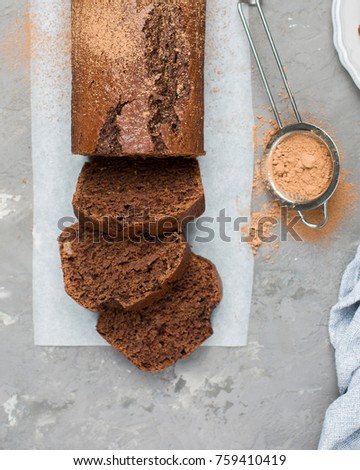 Pieces of chocolate banana cake on a gray concrete background with cocoa powder. Perfect tasty background!)
Flat lay, top view