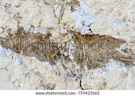 an abstract background, pattern of a part of the wall made of clay and straw