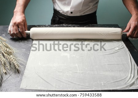 Food pastry. Chef cooking baklava at restaurant. Baker roll dough with kitchen utensil