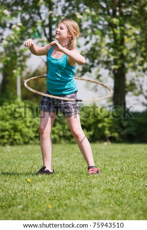 Young girl practising a hula hoop