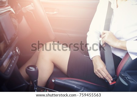 Beautiful Business woman sitting on car seat and fastening seat belt, car safety concept. Royalty-Free Stock Photo #759455563