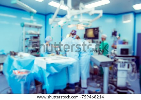 Blurred background with team surgeon at work with laparoscopic equipment in operating room