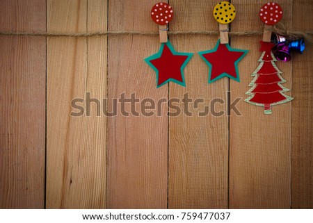 Merry christmas set hang on wooden background.It have christmas tree,star,bell,paper clip and rope.