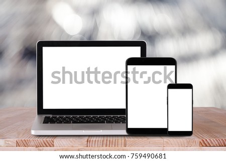 Front view of the laptop, tablet pc, smartphone is on the work table with bokeh background 