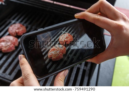 Food photography of grilling burgers on. Home made food photo of beef burger for social networks. Top view mobile phone photo of baked meat.