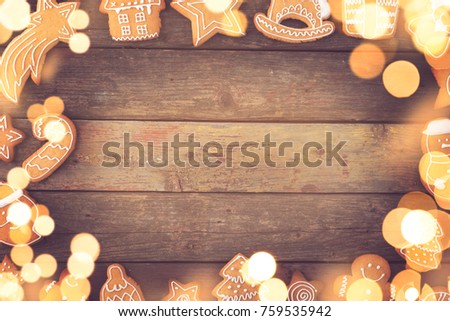 Table top shot of a frame made of nicely decorated gingerbread cookies and Christmas lights