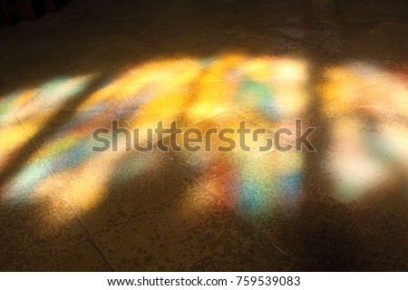 Landscape picture of colored stained glass windows reflected on tile floor captured in Croatia