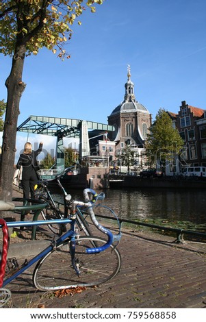 Netherlands.south-holland,leiden august 2016:molested bicycle on the quay side of the Oude Singel with the mare Church in the background