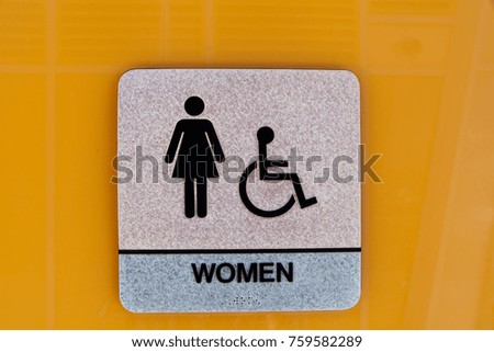 Toilet sign - Men and women signs. Toilets icon, Public restroom signs ,Toilet sign and direction on orange color background. Restroom Concept.