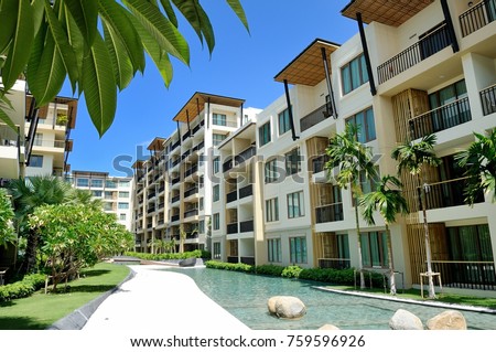 Serviced condominium rental in Hua Hin Thailand located nearby the sea with beautiful scenery of sea view and beach surrounded by swimming pool and greenery trees under clear sky Royalty-Free Stock Photo #759596926