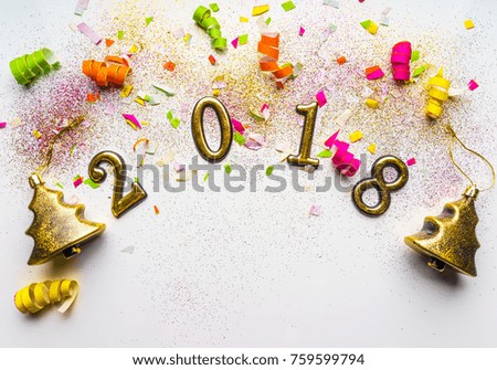 2018 new year background with confetti, sparkles, serpentine, gold Christmas trees, toys, on white. Top view, close-up. Festive greeting card with copy spase