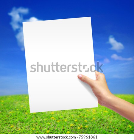 white paper in girl hand on natural background