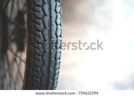 Close up motorcycle wheel parking on the street. Soft focus and burry background
