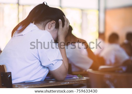 Students taking exam with stress in school classroom. Royalty-Free Stock Photo #759633430