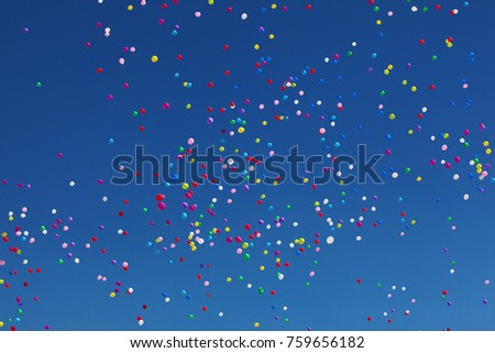 Colorful balloons on blue sky background.