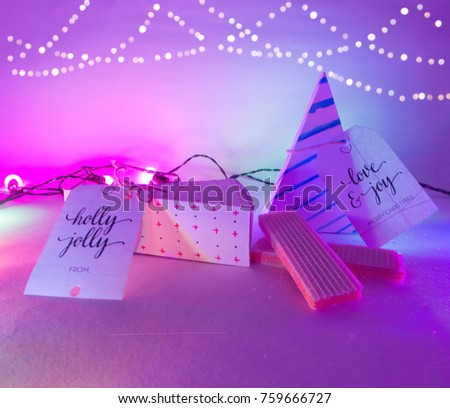 Christmas Decoration with Triangle Wafer Christmas Gift Boxes and wafers in purple lights and golden bokeh for best holiday background image for Holiday invitation and banners