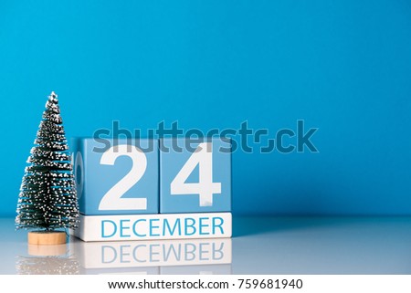 Eve Christmas. December 24th. Day 24 of december month, calendar with little christmas tree on blue background. Winter time. Empty space for text. New year concept Royalty-Free Stock Photo #759681940