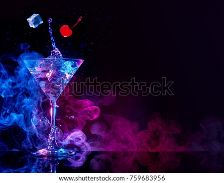 martini cocktail splashing in blue and purple smoky background Royalty-Free Stock Photo #759683956