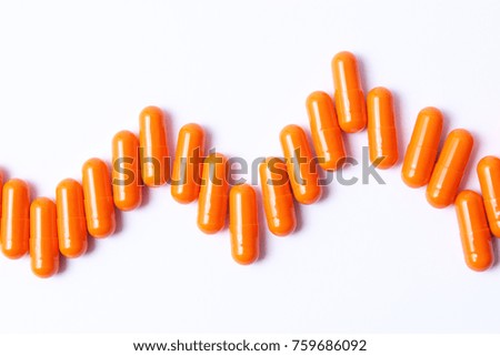 Orange pills with place for text on a white background. Medicine, health.
