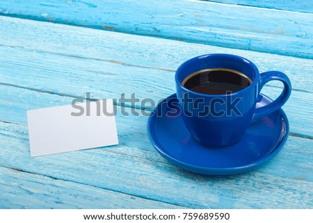 Blank business cards, blue cup on the wooden table. Template for ID. Top view
