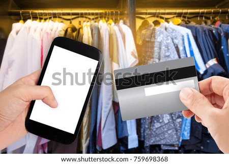 Hand holding smart phone with credit card on blur store, online shopping background, business, E-commerce
